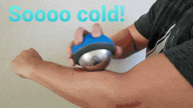 man using cryotherapy massager on arm