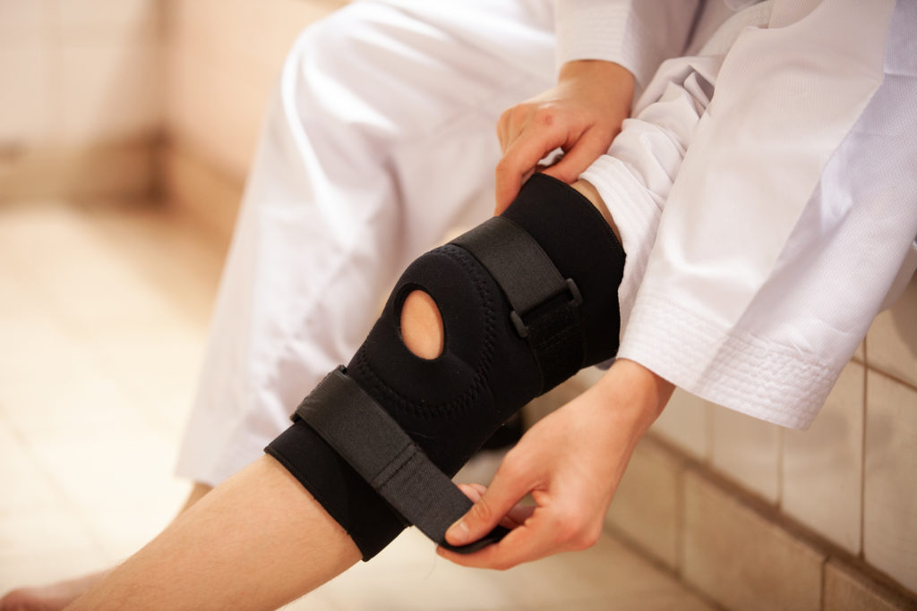 person demonstrating a compression knee brace