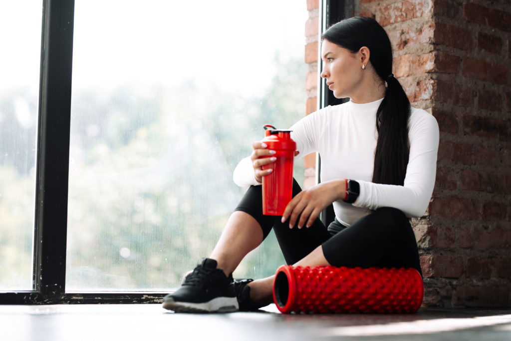 woman holding a water bottle after a workout