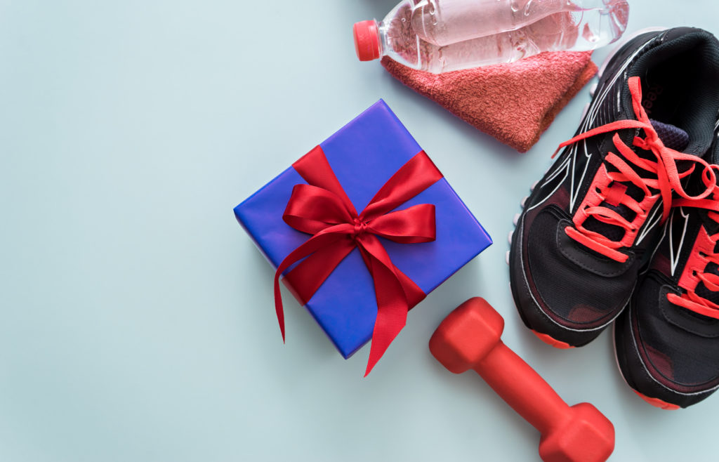Gift box surrounded by workout accessories